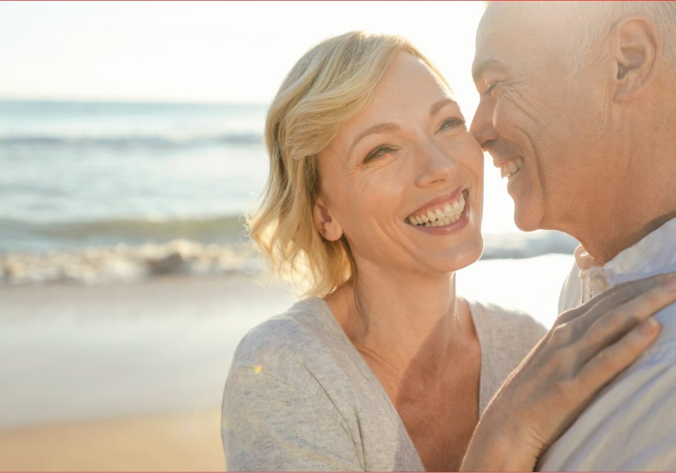 WhyChooseUs iS 978711672 Smiling older couple enjoying a day at the beach, symbolizing vitality and well-being, reflecting positive outcomes of hormone replacement therapy